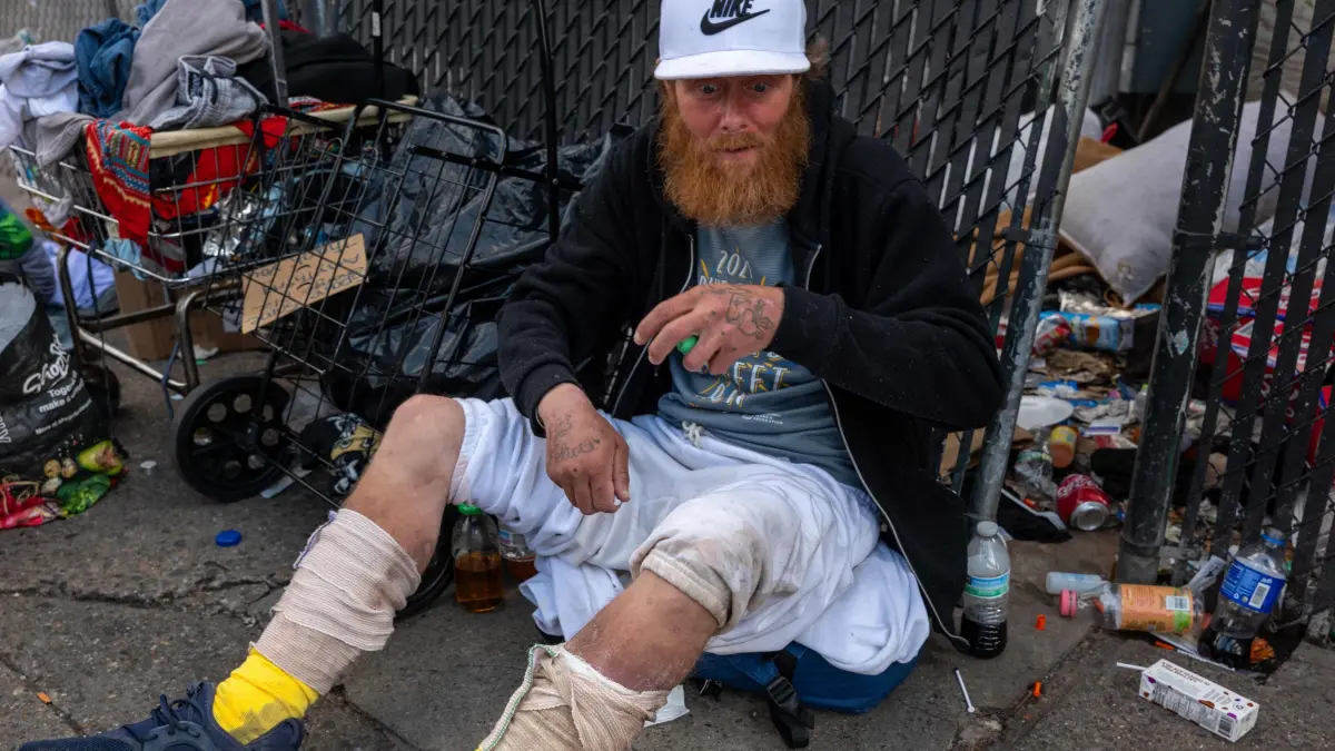 Philadelphia To Clear Homeless Encampment In Kensington: PHILADELPHIA, PENNSYLVANIA - MAY 07: A person sits on the sidewalk ahead of a clearing of a homeless encampment in the Kensington neighborhood on May 07, 2024 in Philadelphia, Pennsylvania. The city of Philadelphia is beginning a long-anticipated clearing of the high drug and crime area where police are closing off part of Kensington Avenue to remove a homeless encampment. An opioid crisis has plagued the area for years and has become what many consider the largest open-air drug market on the East Coast. The new mayor of Philadelphia, Cherelle Parker, had promised to begin the clean-up and has been working with outreach teams and social service agencies to assist with drug treatment and a place to live. Spencer Platt/Getty Images/AFP (Photo by SPENCER PLATT / GETTY IMAGES NORTH AMERICA / Getty Images via AFP)