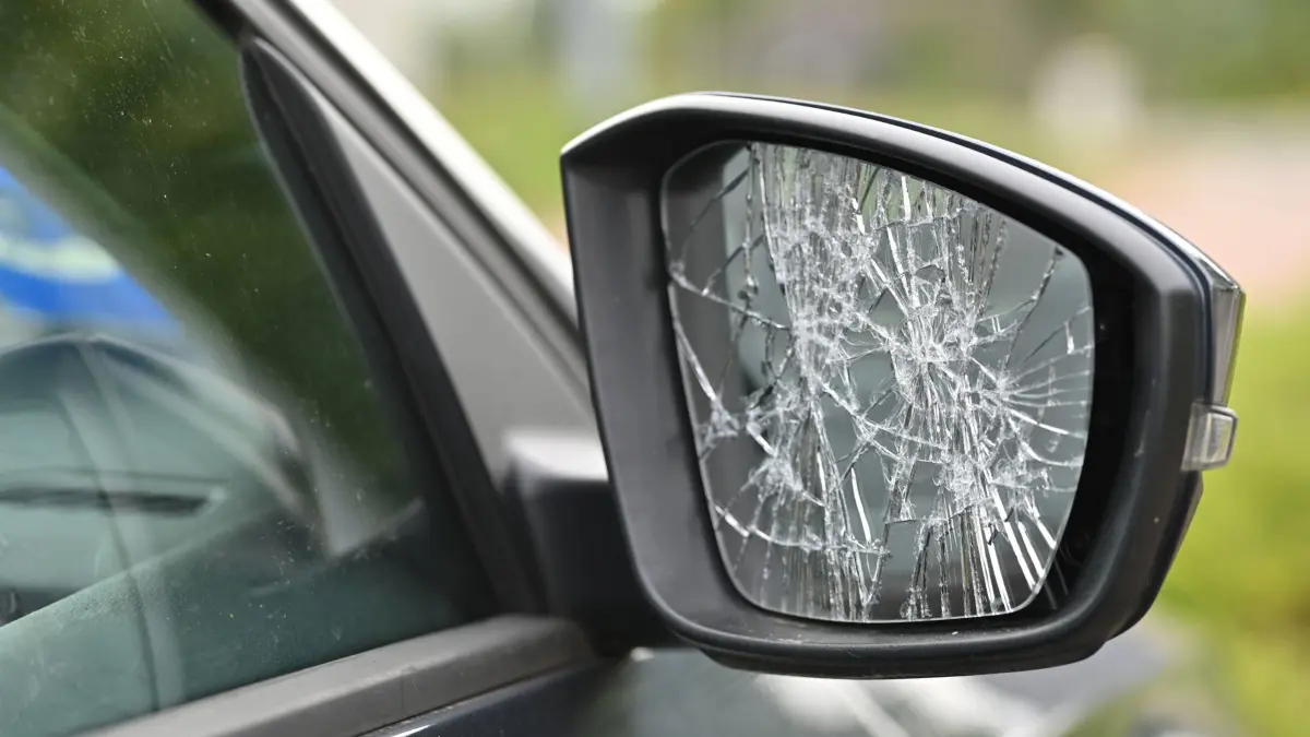Vandalismus, zerschlagener Außenspiegel an einem Auto. *** Vandalism, smashed wing mirror on a car
