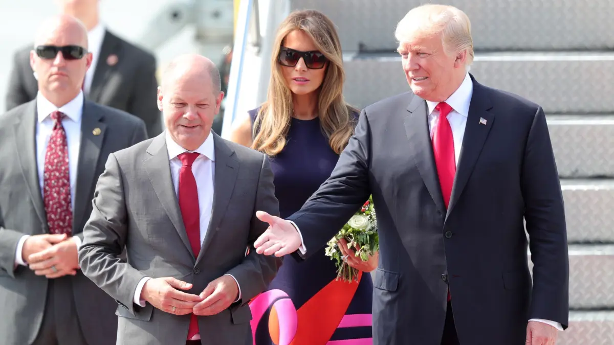 Olaf Scholz und Donald Trump: ARCHIV - 05.07.2017, Hamburg: Der damlige Erste Bürgermeister von Hamburg Olaf Scholz (2. vl) begrüßt den damaligen Präsidenten der Vereinigten Staaten von Amerika (USA), Donald Trump (r), und seine Ehefrau Melania am 06.07.2017 nach ihrer Ankunft in Hamburg zum G20-Gipfel. (zu dpa: «Scholz zu Trump: Transatlantisches Fundament trägt») Foto: Jens Büttner/dpa +++ dpa-Bildfunk +++