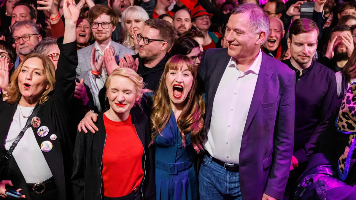 Top candidates of the left-wing Die Linke (The Left) party Heidi Reichinnek (2nd R) and Jan van Aken (R) react with Co-leader of Germany's The Left (Die Linke) party Ines Schwerdtner (2nd L) and with party members during the electoral evening in Berlin on February 23, 2025, after the first exit polls in the German general elections. (Photo by JENS SCHLUETER / AFP)