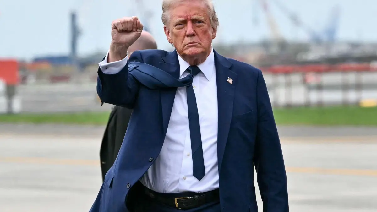 US President Donald Trump visits to attend the funeral of Pope Francis: US President Donald Trump pumps his fist as he steps off Air Force upon arrival at Newark Liberty International Airport in Newark, New Jersey on April 26, 2025. (Photo by Mandel NGAN / AFP)