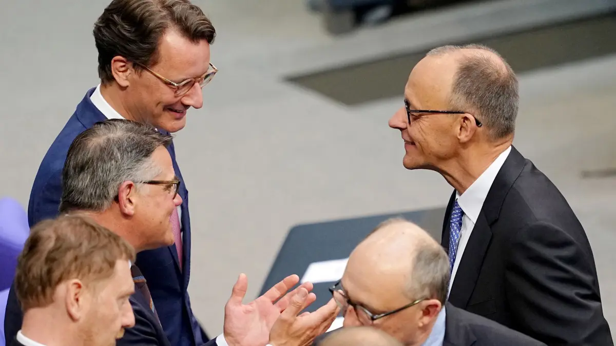 Bundestag - Kanzlerwahl: 06.05.2025, Berlin: Der designierte Bundeskanzler Friedrich Merz (CDU, r), unterhält sich im Bundestag bei der Kanzlerwahl mit den Ministerpräsidenten Michael Kretschmer (Sachsen, CDU, l-r), Boris Rhein (Hessen, CDU) und Hendrik Wüst (CDU), Ministerpräsident des Landes Nordrhein-Westfalen. Im Bundestag findet die Wahl und Vereidigung des Bundeskanzlers und der neuen Bundesregierung statt. Foto: Kay Nietfeld/dpa +++ dpa-Bildfunk +++