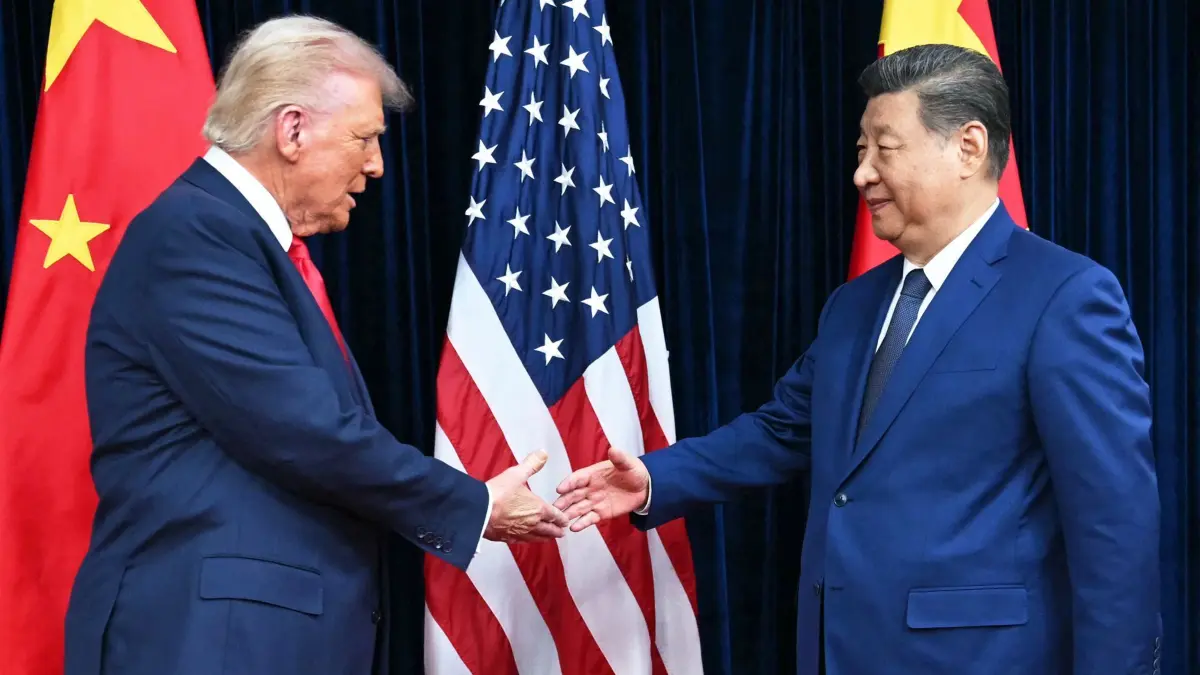 US President Donald Trump (L) extends for a handshake with China's President Xi Jinping as they arrive for talks at the Gimhae Air Base, located next to the Gimhae International Airport in Busan on October 30, 2025. Donald Trump and Chinese leader Xi Jinping will seek a truce in their bruising trade war on October 30, with the US president predicting a "great meeting" but Beijing being more circumspect. (Photo by ANDREW CABALLERO-REYNOLDS / AFP)