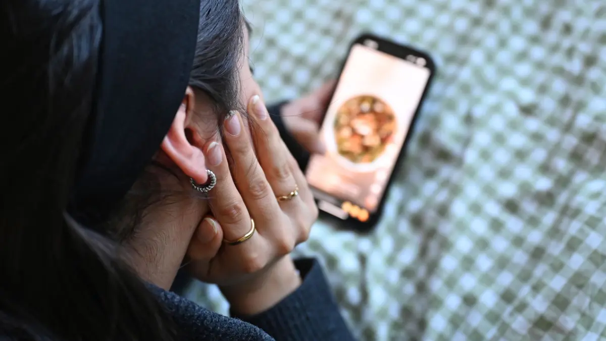 Jugendliche mit Smartphone: ILLUSTRATION - 19.01.2026, Berlin: Eine Jugendliche liegt mit dem Smartphone in der Hand auf dem Bett und scrollt durch die Social-Media-Plattform Tiktok. (zu dpa: «Ruf nach Social-Media-Verbot bis 14 Jahre wird lauter») Foto: Elisa Schu/dpa +++ dpa-Bildfunk +++