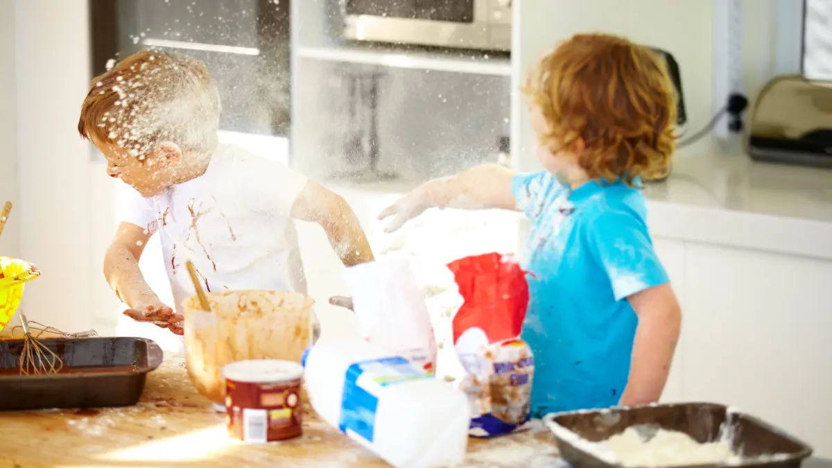 Brother, baking and flour with children fighting in the kitchen while making a mess of their home together. Cooking, recipe and ingredients with boy kids arguing about instructions in a house. model released / property released Copyright: xwww.peopleimages.comx