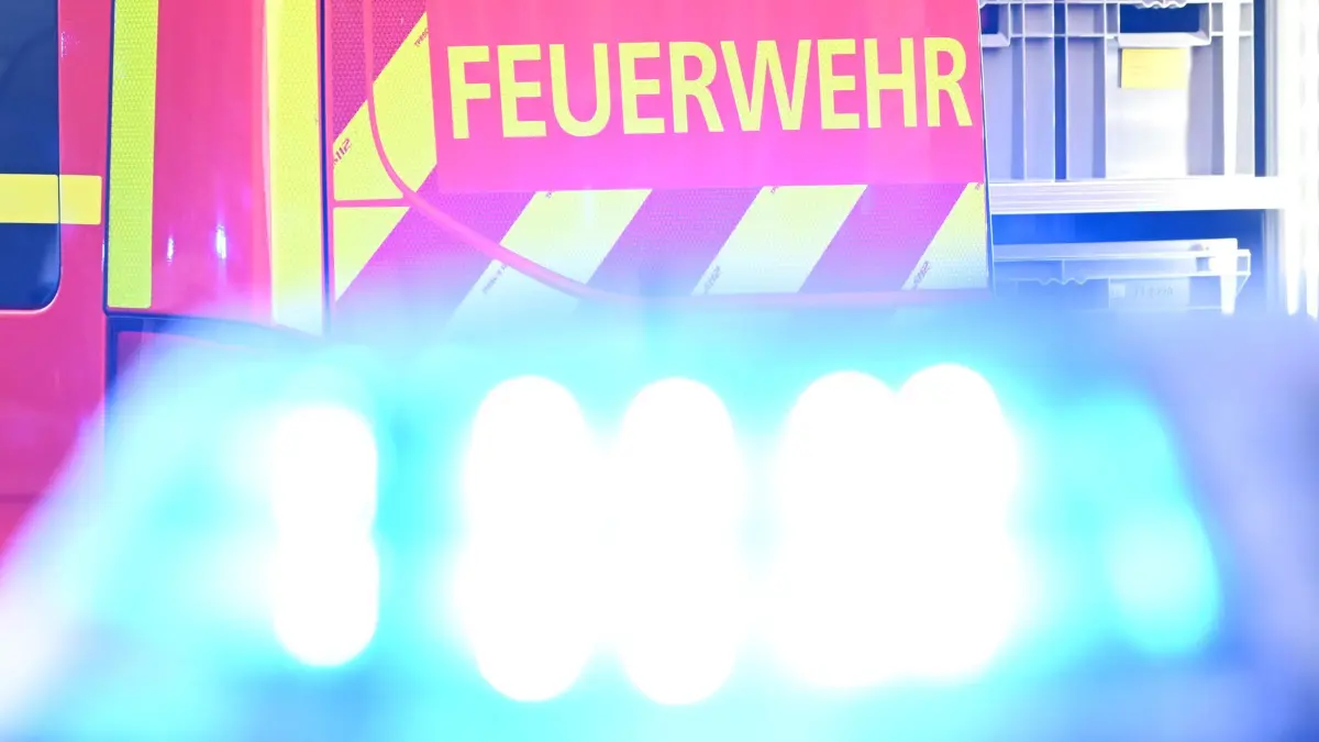 Feuerwehreinsatz in Hamburg: ARCHIV - 02.05.2025, Baden-Württemberg, Stuttgart: Ein Fahrzeug der Feuerwehr steht bei einem Einsatz auf einer Straße, während im Vordergrund das Blaulicht eines Polizeifahrzeugs zu sehen ist. (Symbolfoto) (zu dpa: «Kurzschluss legt S1 in Hamburg lahm – stundenlange Sperrung») Foto: Bernd Weißbrod/dpa +++ dpa-Bildfunk +++
