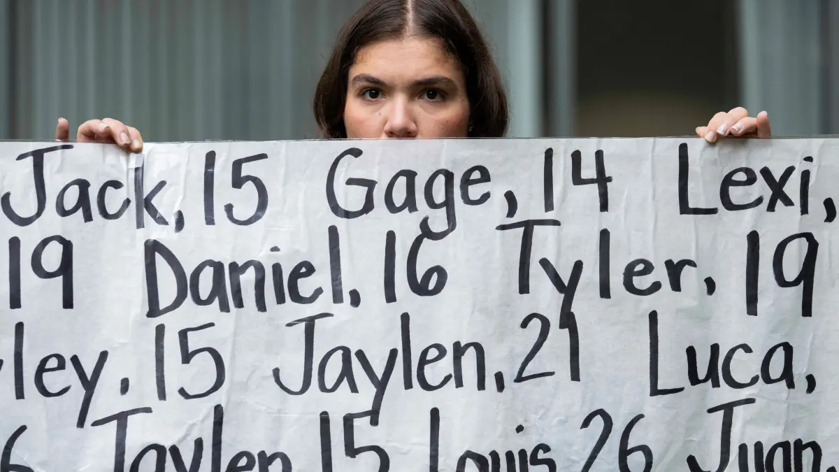 Meta on trial with 30 US states suing over social media addiction: (FILES) Olivia Konar holds a banner with the names of nearly 400 young people who allegedly died from the impacts of social media outside the Ronald V. Dellums Federal Building & United States Courthouse in Oakland, California, on August 18, 2026, as opening arguments begin in the Meta trial over a lawsuit brought by US states about social media addiction. Meta agreed to pay a coalition of US states as much as $16.7 billion and to impose sweeping new limits on how teenagers use Facebook and Instagram, according to a court filing on August 26, 2026, that ends a landmark trial in California. The proposed settlement, filed in federal court, would resolve claims by 29 states that Meta deliberately engineered its platforms to hook young users, misled the public about the risks and unlawfully collected data from children under 13. (Photo by Godofredo A. VÁSQUEZ / AFP)