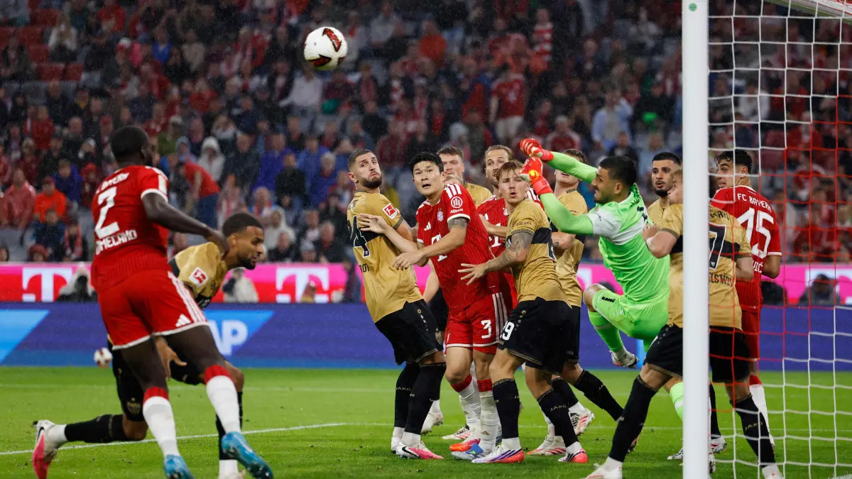 FBL-GER-BUNDESLIGA-BAYERN MUNICH-STUTTGART: Stuttgart's German goalkeeper #01 Fabian Bredlow (3R) saves the ball during the German first division Bundesliga football match between FC Bayern Munich and VfB Stuttgart in Munich, southern Germany, on August 28, 2026. (Photo by Alexandra BEIER / AFP) / DFL REGULATIONS PROHIBIT ANY USE OF PHOTOGRAPHS AS IMAGE SEQUENCES AND/OR QUASI-VIDEO