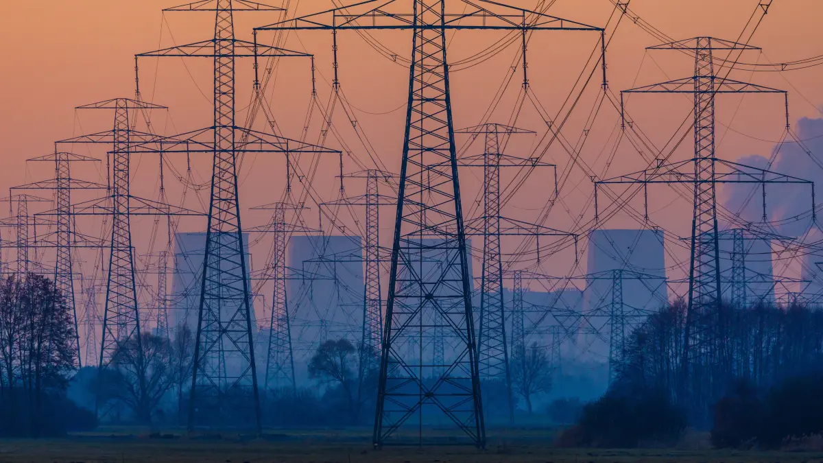 Das Braunkohlekraftwerk Jänschwalde e und Stromleitungsmasten sind bei Sonnenaufgang bei Tauer in der Nähe von Peitz in der Lausitz zu sehen.