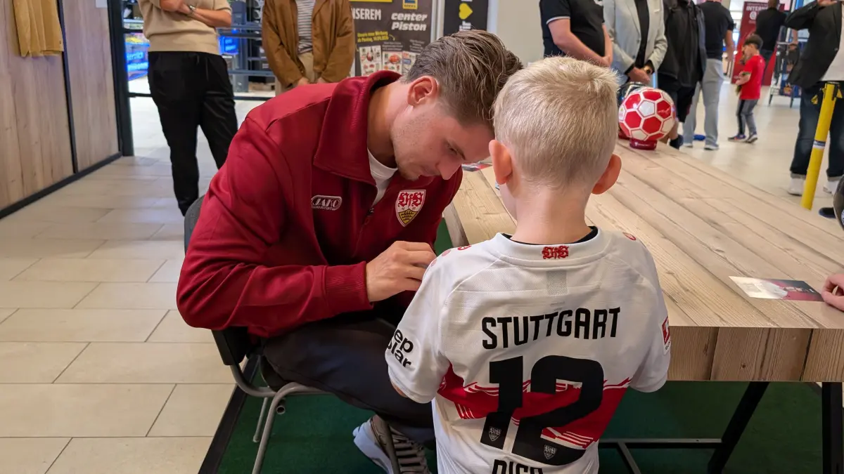 Ramon Hendriks unterschreibt das Trikot eines jungen VfB-Fans.