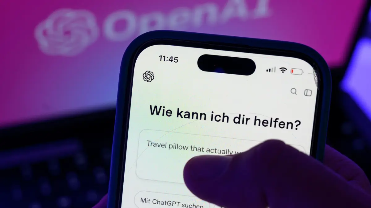 Smartphone mit dem KI-Chatbot ChatGPT vor dem Logo von OpenAI: ILLUSTRATION - Wer ChatGPT kostenlos nutzt, kann seit dem 24. August 2026 kontextbezogene Werbung erhalten. (zu dpa: «Werbung bei ChatGPT: Bei KI-Empfehlung noch genauer hinsehen») Foto: Hendrik Schmidt/dpa/dpa-mag - Honorarfrei nur für Bezieher des Dienstes dpa-Magazin +++ dpa-Magazin +++