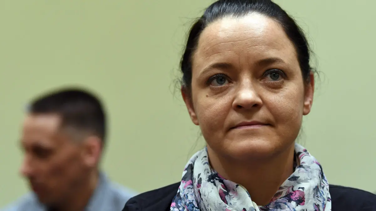 FILES-GERMANY-JUSTICE-TRIAL-NSU-ZSCHAEPE: (FILES) Defendant Beate Zschaepe (R) waits in front of co-defendant Ralf Wohlleben, one of four alleged supporters of the neo-Nazi cell NSU, prior the continuation of their trial at a courtroom in Munich, southern Germany, on July 3, 2018. Zschaepe, 43, was accused of complicity in 10 deadly shootings of mostly Turkish and Greek-born immigrants carried out by clandestine trio the National Socialist Underground (NSU). The Higher Regional Court of Munich announced on October 27, 2026 that Zschaepe, who has been in custody since 2011, must remain in prison at least until 2035. (Photo by Christof STACHE / POOL / AFP)