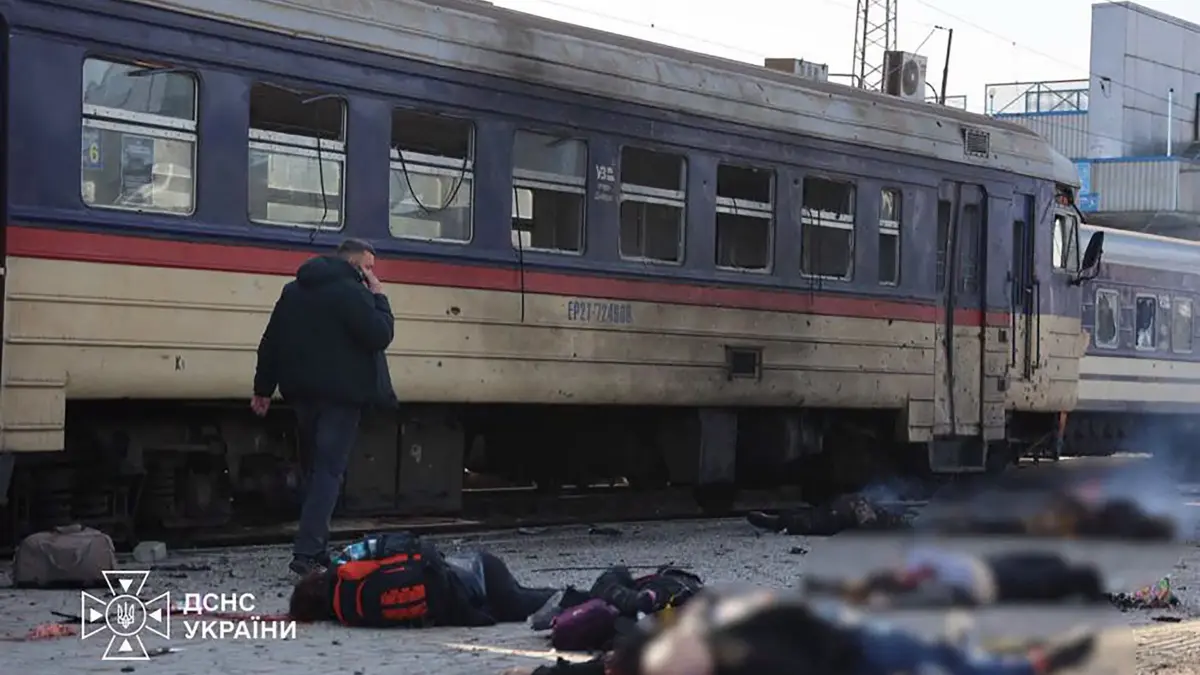 UKRAINE-RUSSIA-CONFLICT-WAR: EDITORS NOTE: Graphic content / In this handout photograph taken and released by the Ukrainian Emergency Service on October 29, 2026, a man walks past the bodies of victims lying next to a damaged passenger train following an air attack on the railway station in Dnipro, amid the Russian invasion of Ukraine. At least 13 people were killed when a Russian drone slammed into a platform at the Dnipro railway station in central Ukraine, where a train was parked, Ukrainian authorities said on October 29, 2026. (Photo by Handout / UKRAINIAN EMERGENCY SERVICE / AFP) / RESTRICTED TO EDITORIAL USE - MANDATORY CREDIT "AFP PHOTO / UKRAINIAN EMERGENCY SERVICE" - HANDOUT - NO MARKETING NO ADVERTISING CAMPAIGNS - DISTRIBUTED AS A SERVICE TO CLIENTS - AFP CANNOT INDEPENDENTLY VERIFY THE AUTHENTICITY OR LOCATION, DATE, AND CONTENT OF THESE IMAGES / GRAFFIC CONTENT, DIGITALLY ALTERED BY THE SOURCE